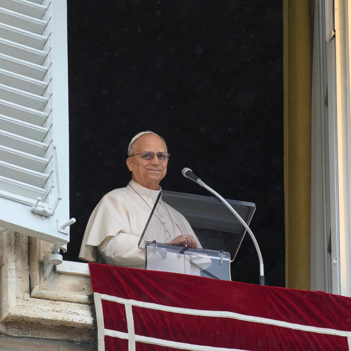 Pope Leo XIV reacts as he leads the Angelus prayer from a window of the Apostolic Palace, at the Vatican, March 22, 2026. Vatican Media/­Matteo Pernaselci/Handout via REUTERS