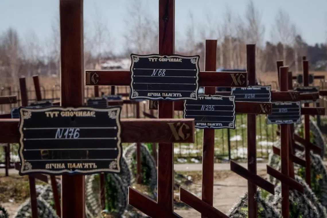 Graves of unidentified people killed by Russian soldiers during the occupation of Bucha, in Ukraine, are seen at the town's cemetery, ahead of the first anniversary of the town's liberation.