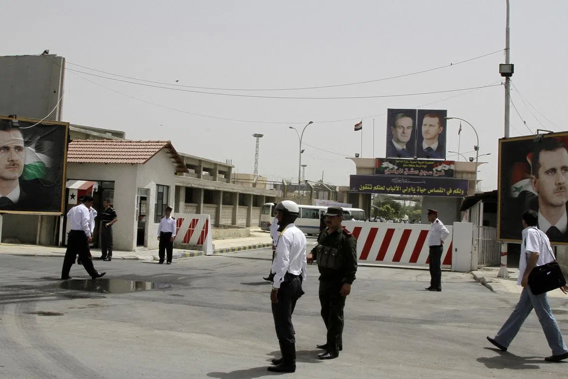 FILE PHOTO: Police stand at the gate of Damascus Central Prison in the Adra area near the Syrian capital of Damascus in this May 28, 2010 file photo. REUTERS/Khaled al-Hariri/Files/File Photo