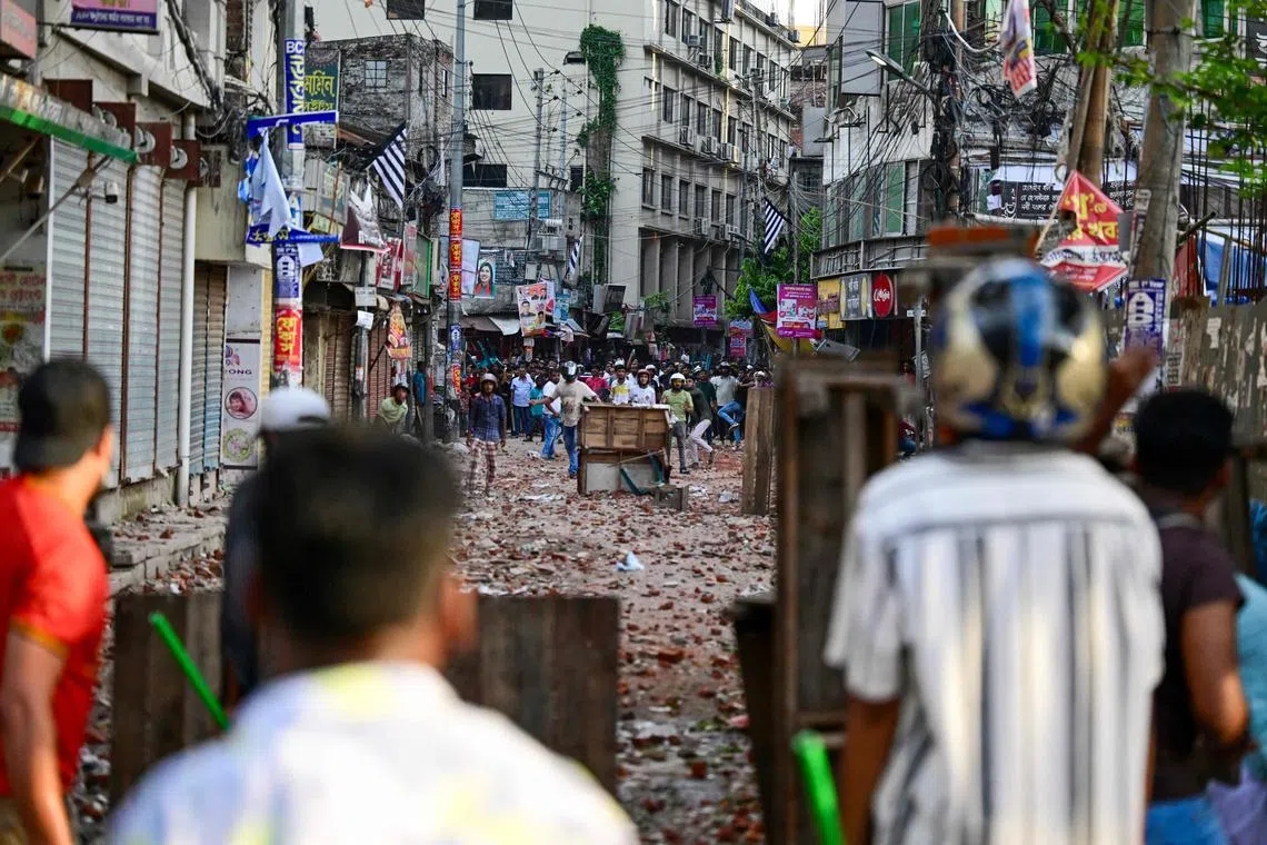 Protesters and students backing the ruling Awami League party clashing in Dhaka on July 16.