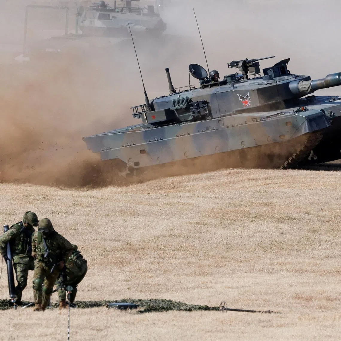 FILE PHOTO: Type 10 tanks operate during an annual New Year military drill by the Japanese Ground Self-Defense Force 1st Airborne Brigade at Narashino exercise field in Funabashi, east of Tokyo, Japan January 11, 2026. REUTERS/Kim Kyung-Hoon      TPX IMAGES OF THE DAY/File Photo
