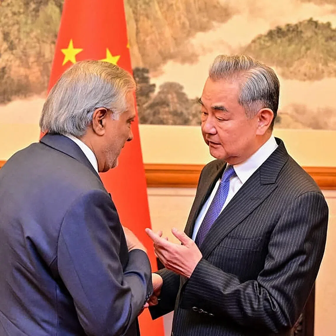 This handout photograph taken on March 31, 2026 and released by Pakistan's Ministry of Foreign Affairs shows China's Foreign Minister Wang Yi (R) speaking with his Pakistani counterpart Ishaq Dar in Beijing. China and Pakistan will "strengthen" their cooperation on Iran, Beijing's foreign ministry said on March 31, as senior Islamabad officials visited the Chinese capital. (Photo by Pakistan's Ministry of Foreign Affairs / AFP) / RESTRICTED TO EDITORIAL USE - MANDATORY CREDIT "AFP PHOTO/Pakistan's Ministry of Foreign Affairs/-" - HANDOUT - NO MARKETING NO ADVERTISING CAMPAIGNS - DISTRIBUTED AS A SERVICE TO CLIENTS