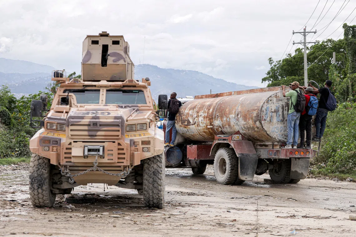 FILE PHOTO: An armored personnel carrier of Haiti's UN-backed Gang Suppression Force (GSF) patrols an area after El Salvador announced a rescue mission for four air force members in the GSF that went missing after a gang ambush, in Port-au-Prince, Haiti, October 23, 2026. REUTERS/Patrice Noel/File Photo