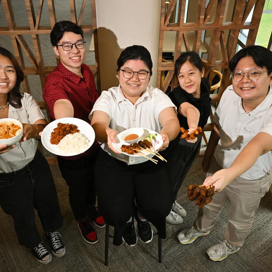 ST20230315-202370764349-Lim Yaohui-Josiah Teo-jtmeat15/
(From left) Cheryl Pow, 20; Jacob Ang, 20; Kathleen Tay, 21; Annabel Teo, 20; and Benedict Lim, 20; all final year Temasek Polytechnic students taking diploma in food, nutrition, and culinary science, with their dishes at Bistro Lab in Temasek Polytechnic on Mar 15, 2023.
Temasek Polytechnic students, research scientists and lecturers, together with Japanese food tech giant Fuji Oil have created Singapore's plant-based versions of local hawker delights. The No-MOO Satay (Vegan Beef satay), No-CLUCK Satay (Vegan Chicken satay), Wow-gyu Rendang (Vegan Beef Rendang) and Shojin Laksa (Vegan Laksa) are the polytechnic's first endeavour into meat-free options developed as a student project.
Using Fuji Oil's textured vegetable protein (TVP), high moisture meat analogue (HMMA) and other ingredients, the team was able to recreate the "meat-less" dishes without compromising on the traditional taste that Singaporeans are familiar with. Combining food tech and local aromatic spices, including Fuji Oil's proprietary ingredients utilising MIRACORE(tm) technologies to bring out the inherent flavours of the dishes, the outcome proves that the combination of tech and food science need not sacrifice taste and texture, an important addition to Singapore's sustainable food options.
The project not only resulted in delicious meat-free options for Singapore, but Fuji Oil Singapore will also hire 2 graduating students from the Diploma in Food Science & Nutrition who worked on this as their final-year project.
(ST PHOTO: LIM YAOHUI)