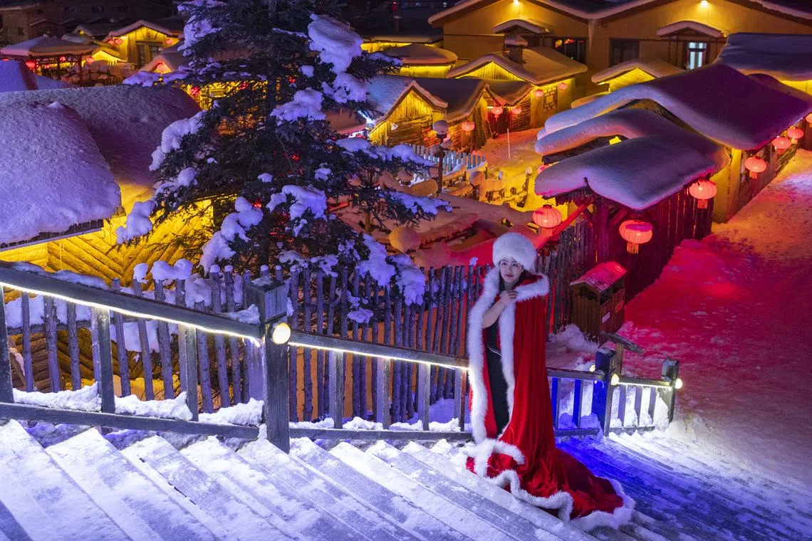 A tourist in rented costumes poses for photos at the Snow Town scenic spot in Hailin City in northeast China's Heilongjiang Province, 13 December 2022. The Snow Town scenic spot officially opened recently. Enjoying a seven-month snow season, it has become an attraction for tourists for years.
