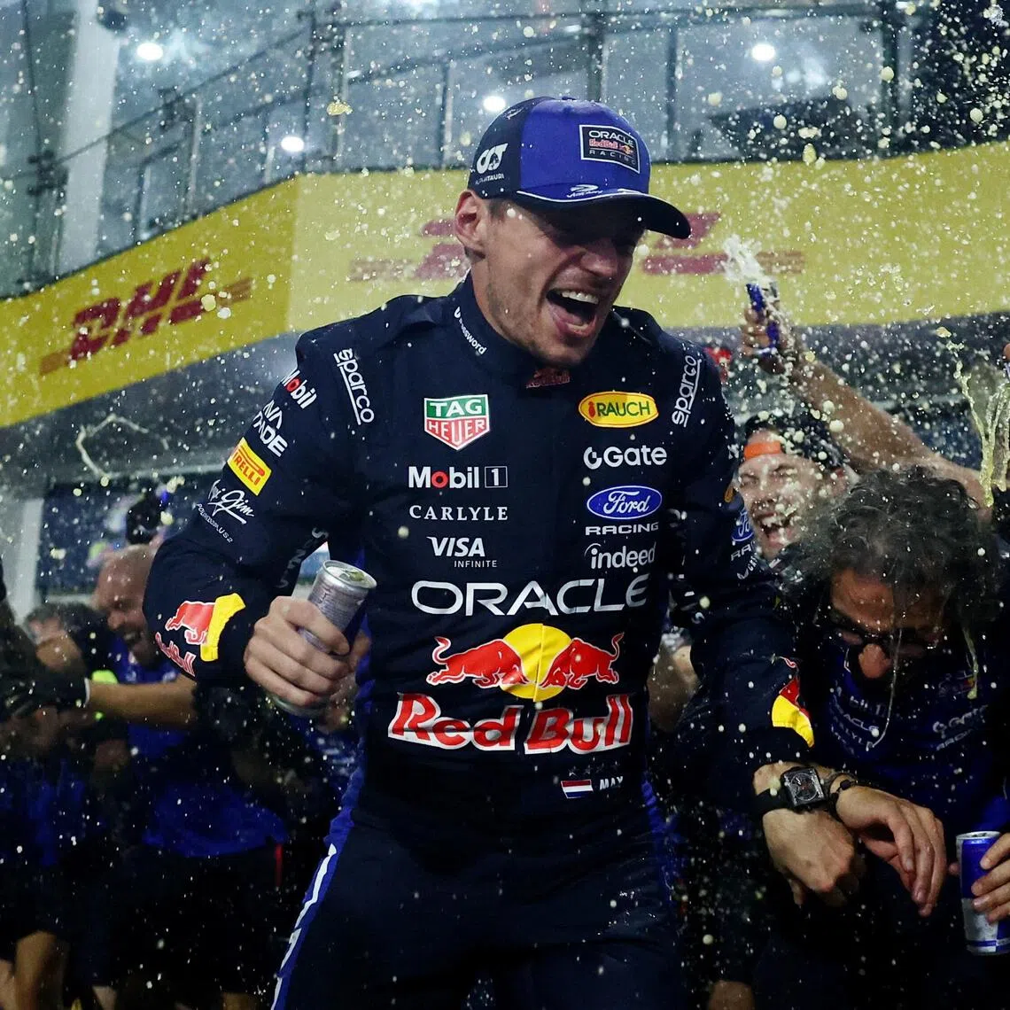 Red Bull’s Max Verstappen celebrating with team principal Laurent Mekies and his teammates after winning the Bahrain Grand Prix in Malaysia on Oct 4.