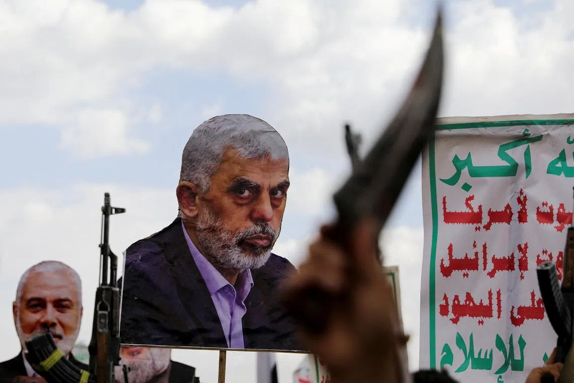 FILE PHOTO: A person holds a cut-out depicting late Hamas leader Yahya Sinwar as protesters, predominantly Houthi supporters, demonstrate to show solidarity with the Palestinians in the Gaza Strip and to condemn the U.S. strikes in Yemen, in Sanaa, Yemen April 11, 2025. REUTERS/Khaled Abdullah/File Photo