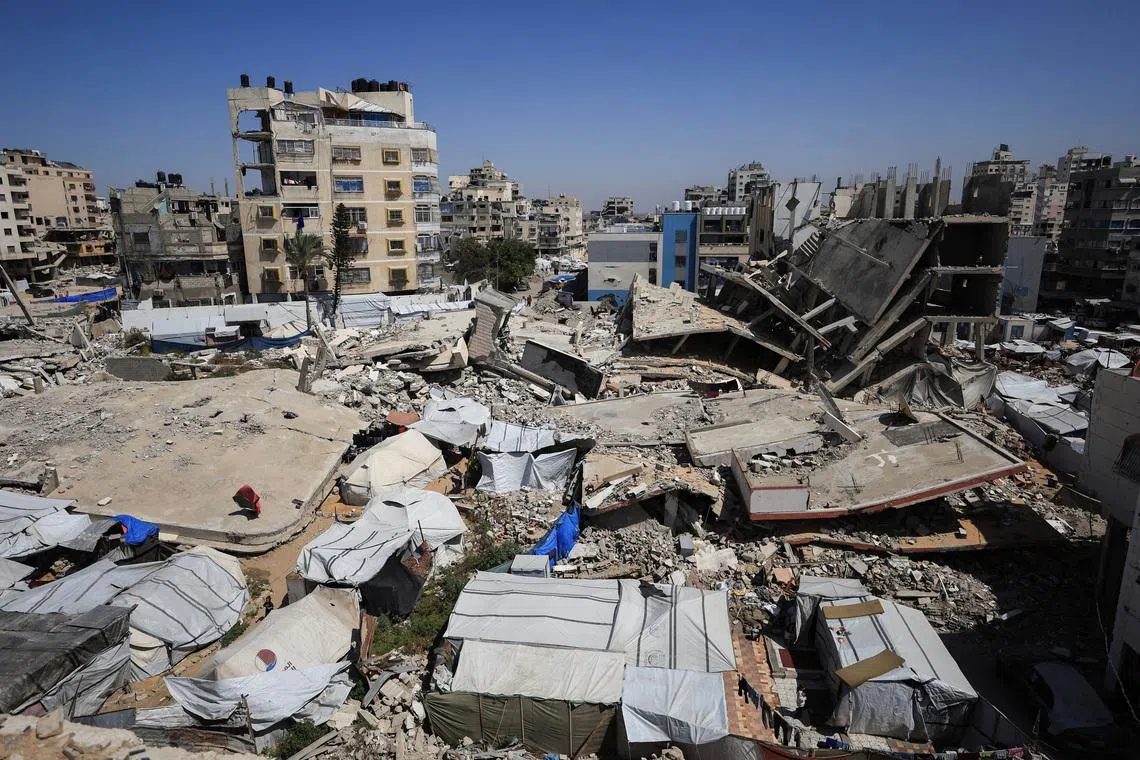 Tents sheltering displaced Palestinians amidst the rubble of residential buildings destroyed during the two-year Israeli offensive in Gaza City, May 11, 2026. REUTERS/Dawoud Abu Alkas