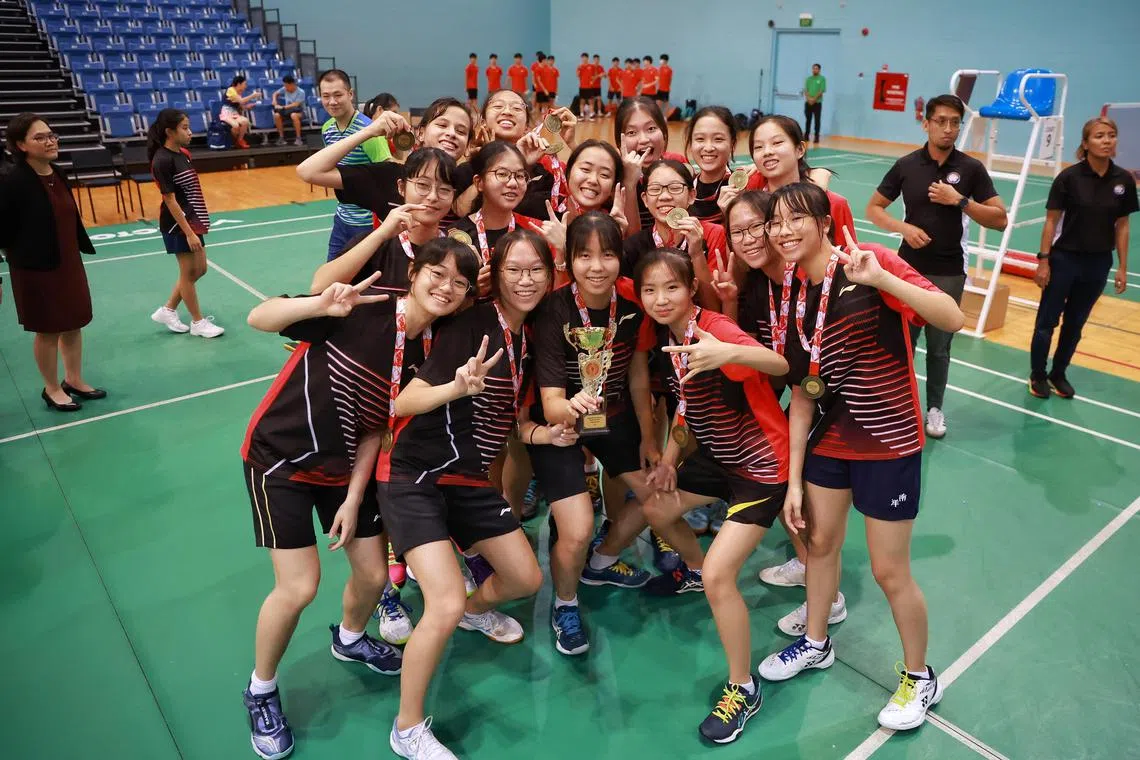 Nanyang Girls’ School players with their trophy and first place medals from the National School Games B division Badminton girls’ final at OCBC Arena Hall 2 on April 17, 2023.