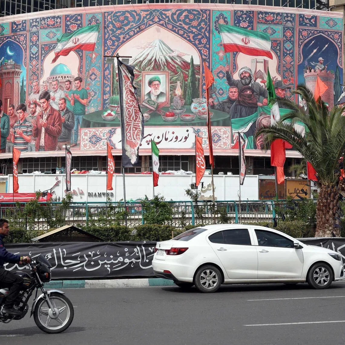 A billboard with a portrait of Iran's slain supreme leader, Ayatollah Ali Khamenei (centre), in Tehran on March 22.