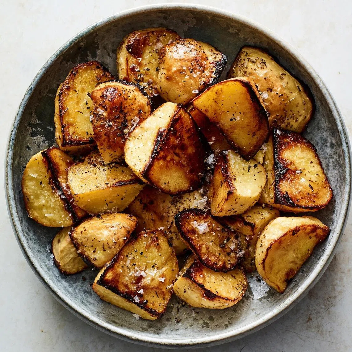 This uses the Greek method of roasting potatoes in olive oil, lemon juice and stock.