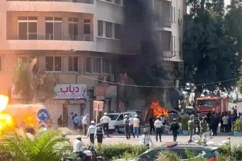 Emergency personnel working at the site of an explosion, near a hotel where French President Emmanuel Macron was meant to be staying, in Damascus, Syria, on July 7.