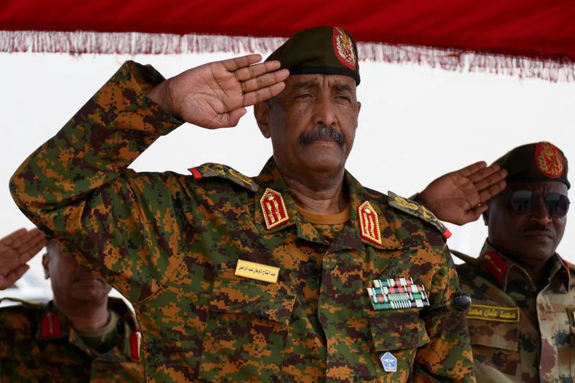 Sudan's General Abdel Fattah al-Burhan salutes as he listens to the national anthem after landing in the military airport of Port Sudan on his first trip away following the crisis in Sudan's capital Khartoum since an internal conflict broke out, in the city of Port Sudan, Sudan, August 27, 2023. REUTERS/Ibrahim Mohammed Ishak/File Photo