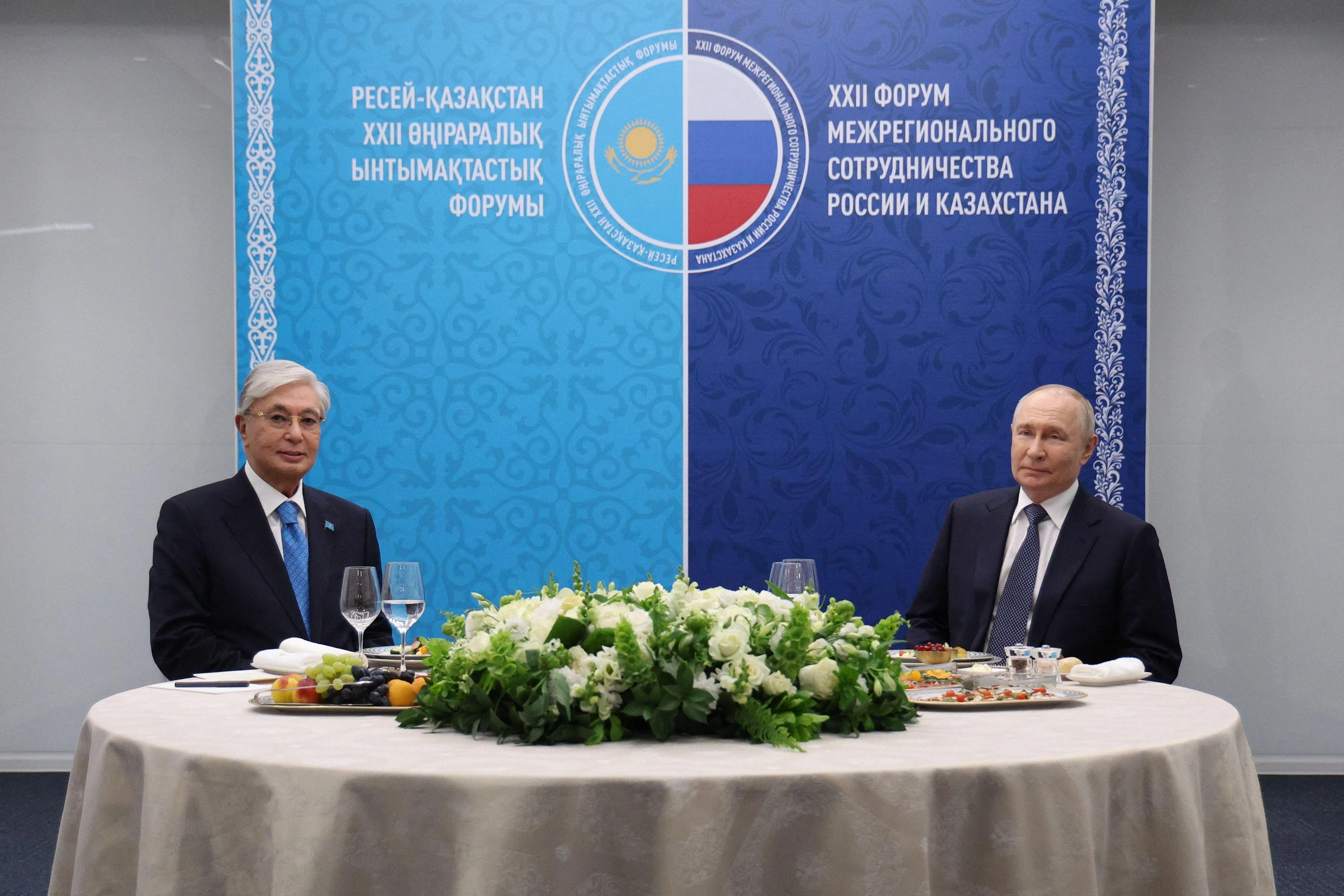 In this pool photograph distributed by the Russian state agency Sputnik, Russia's President Vladimir Putin (R) and Kazakhstan's President Kassym-Jomart Tokayev have lunch during the 22nd Russia-Kazakhstan Forum of Interregional Cooperation in Omsk on July 25, 2026. (Photo by Vyacheslav PROKOFYEV / POOL / AFP)