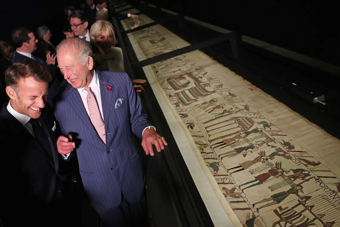Britain's King Charles and France's President Emmanuel Macron react during a preview event for the Bayeux Tapestry Exhibition, at British Museum in London, Britain, September 2, 2026.  Adrian Dennis/Pool via REUTERS