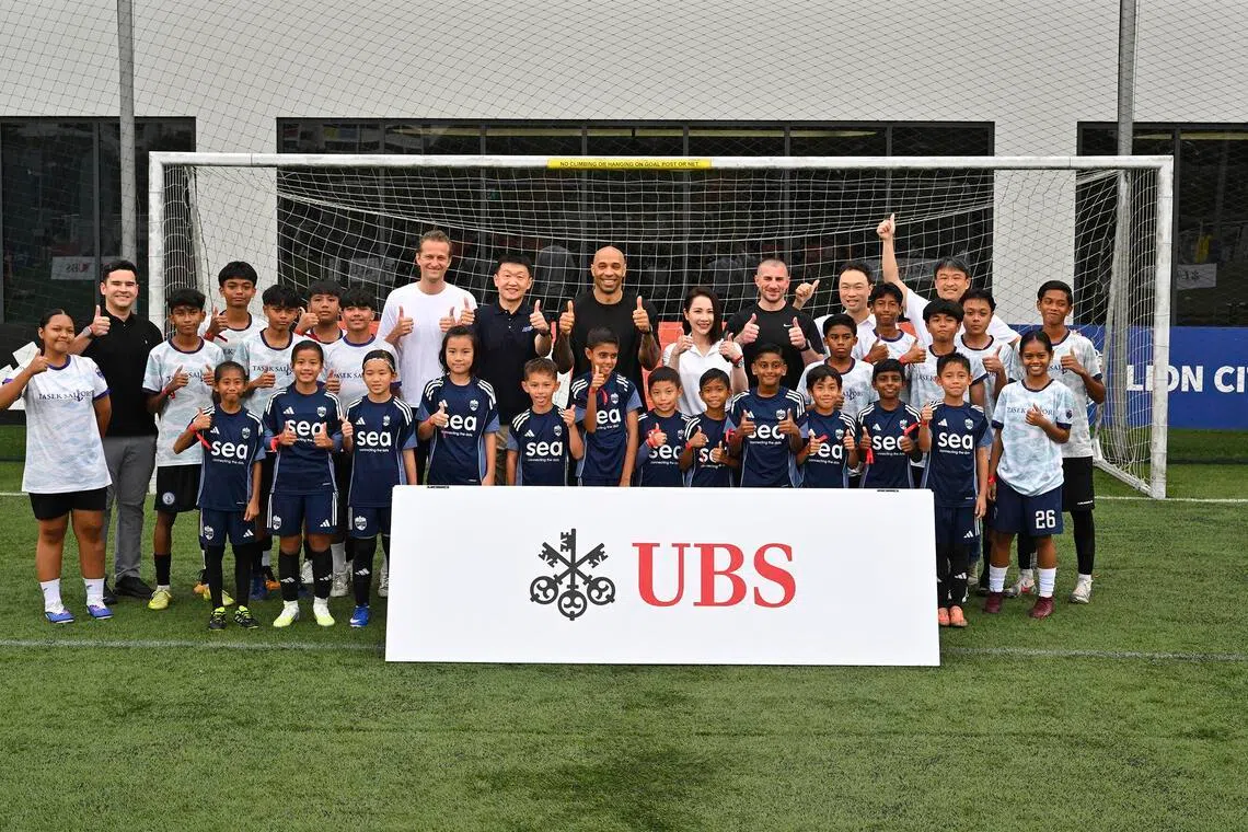 Thierry Henry (centre) in a group photo taken with kids from the Lion City Sailors' academy and Tasek Football Academy, at a UBS event at the Sailors' training centre on May 25.