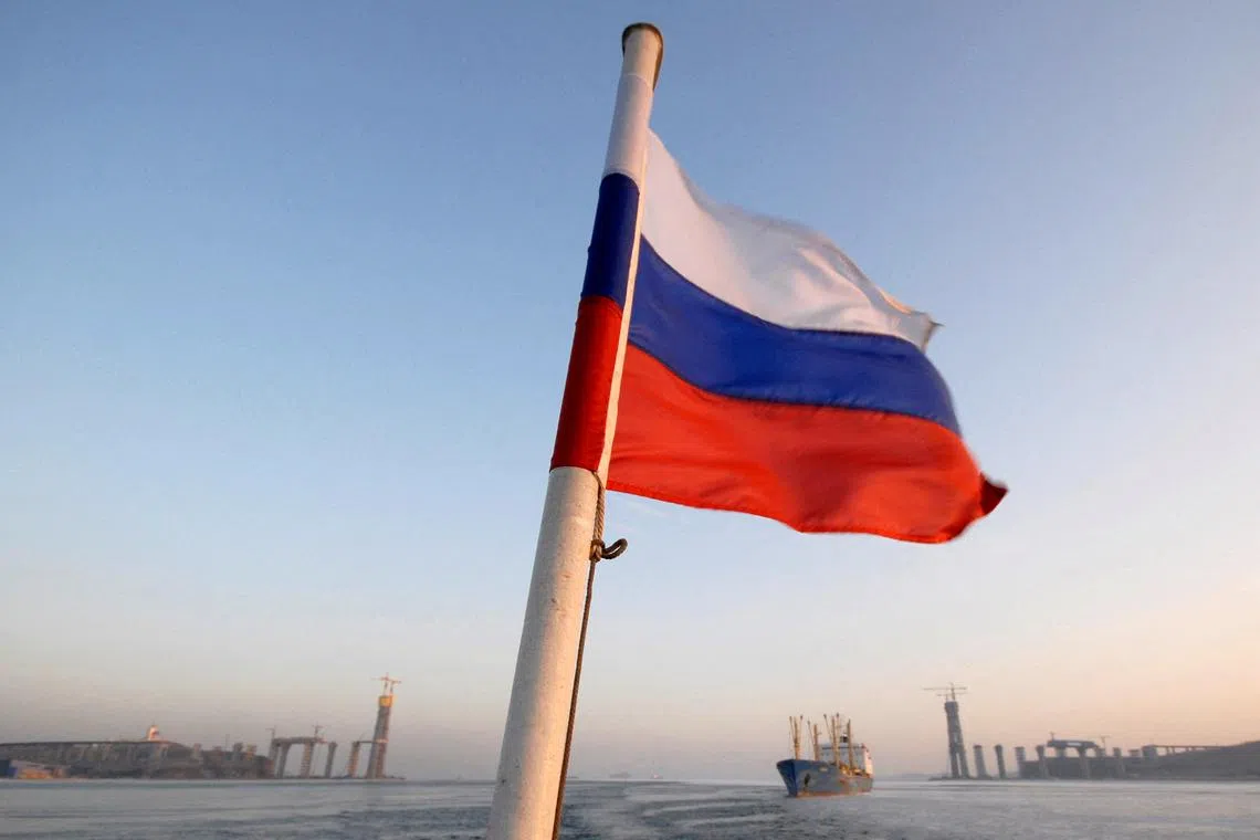 FILE PHOTO: The Russian national flag flies on a vessel moving along the strait of East Bosphorus in Vladivostok January 27, 2011. REUTERS/Yuri Maltsev/File Photo