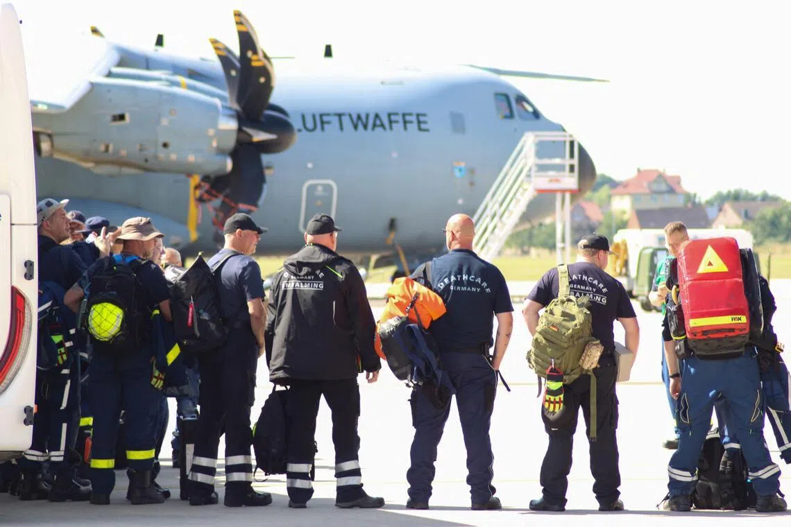 Rescuers from Germany prepare to board a military transport aircraft bound for earthquakes-devastated Venezuela.