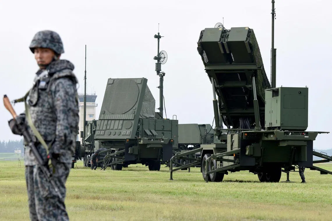Soldiers from the Japan Air Self-Defense Force setting up PAC-3 surface-to-air missile launch systems during a temporary deployment drill at US Yokota Air Base in western Tokyo.  