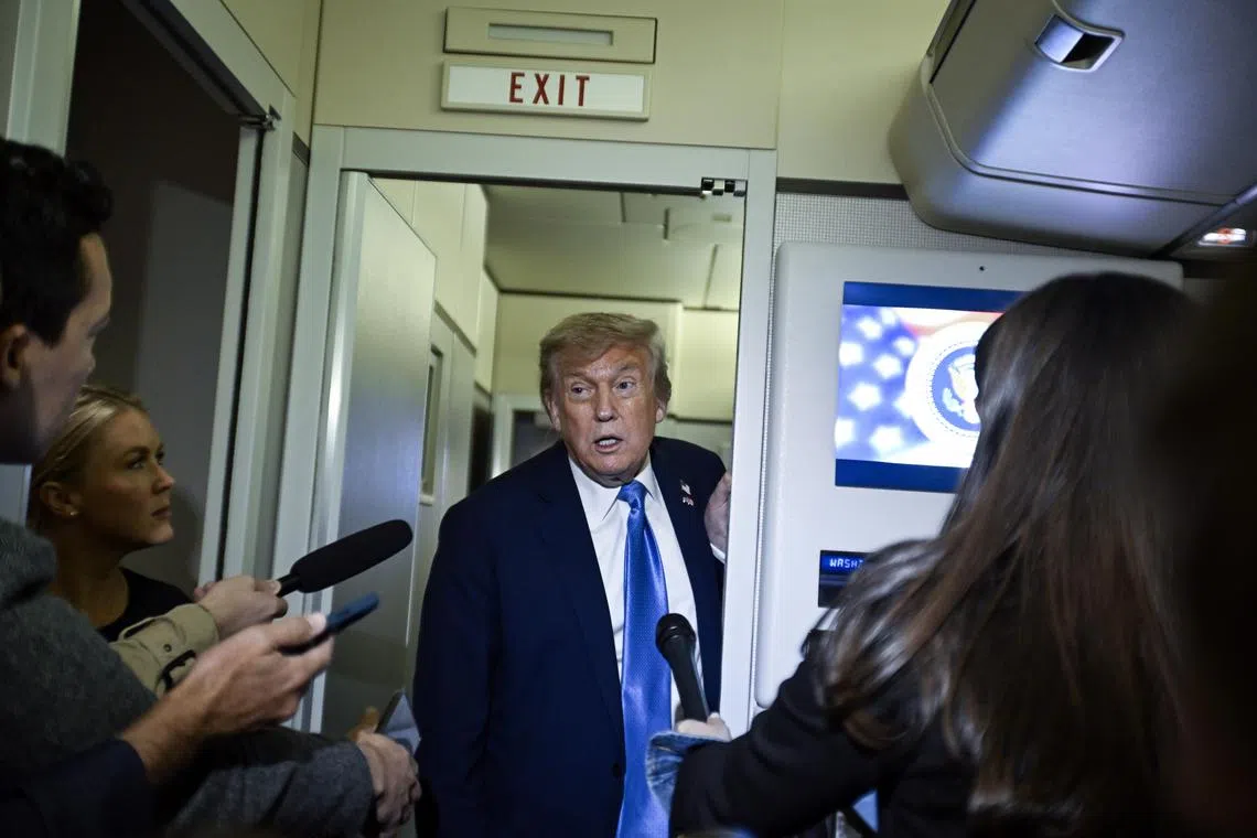 US President Donald Trump speaking to reporters on Air Force One after making an early exit from the G-7 Summit in Canada on July 16.