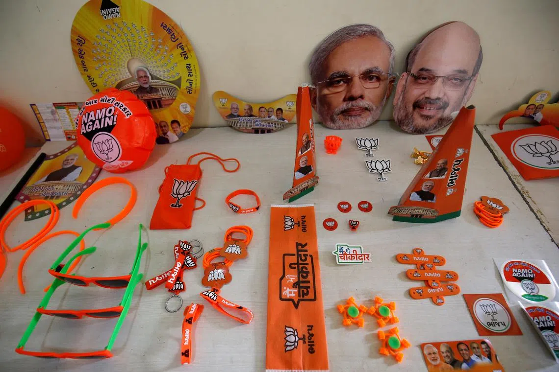 Wristbands, key chains and badges featuring India's ruling Bharatiya Janata Party (BJP) and masks of the party president Amit Shah and Prime Minister Narendra Modi are on display inside a BJP office ahead of general election in Gandhinagar, Gujarat, India, April 3, 2019. REUTERS/Amit Dave/File Photo