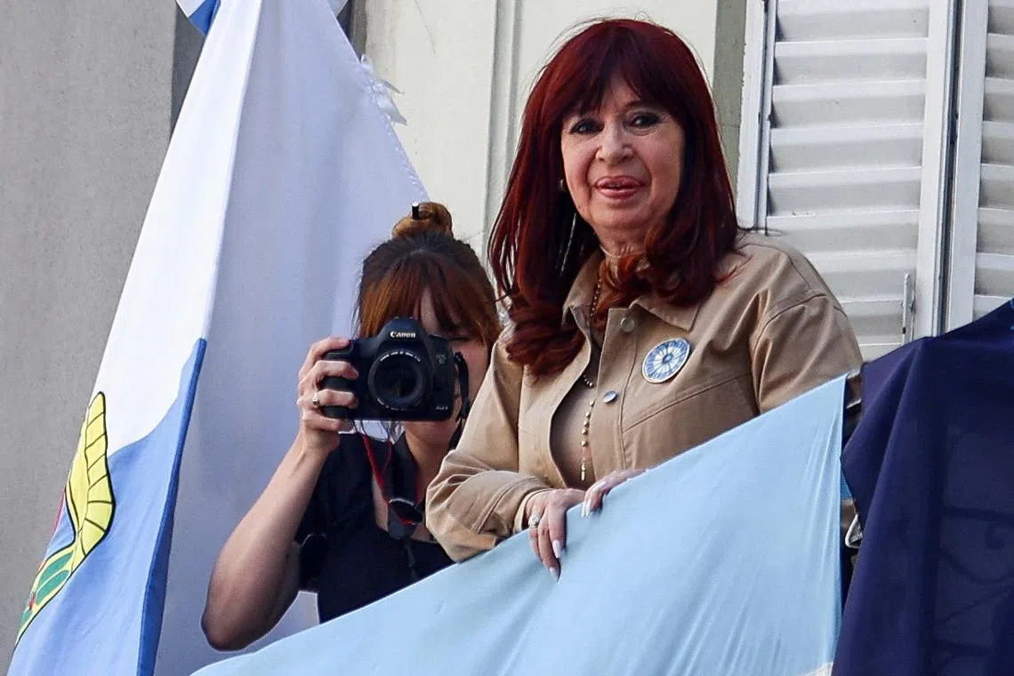Argentina's former President Cristina Fernandez de Kirchner stands on a balcony, on the day the Federal Court of Criminal Appeals confirmed a prison sentence on charges of alleged corruption in the awarding of public works during her presidency, in Buenos Aires, Argentina November 13, 2024. REUTERS/Matias Baglietto/File Photo