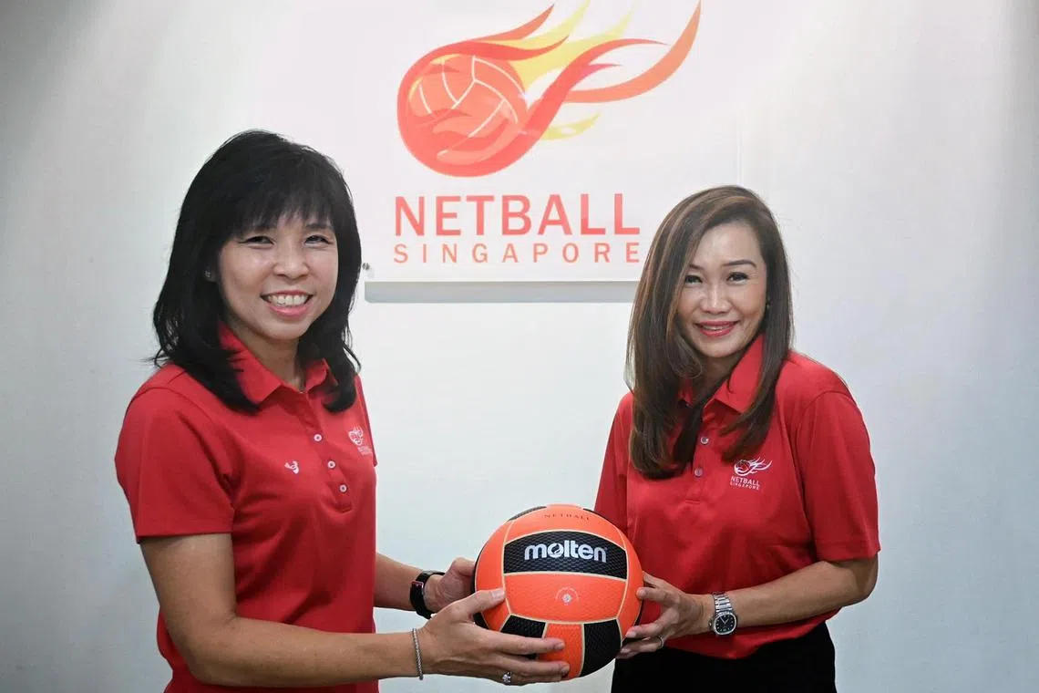 Netball Singapore's outgoing president Jessica Tan (left) handing over the ball to new president Trina Liang-Lin on Sept 22.