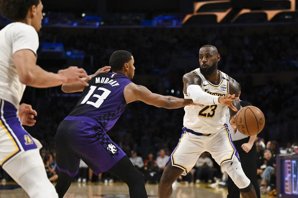 Los Angeles Lakers forward LeBron James passing the ball as Sacramento Kings forward Keegan Murray defends in their NBA game at Crypto.com Arena on Oct 26, 2024 in Los Angeles, California.