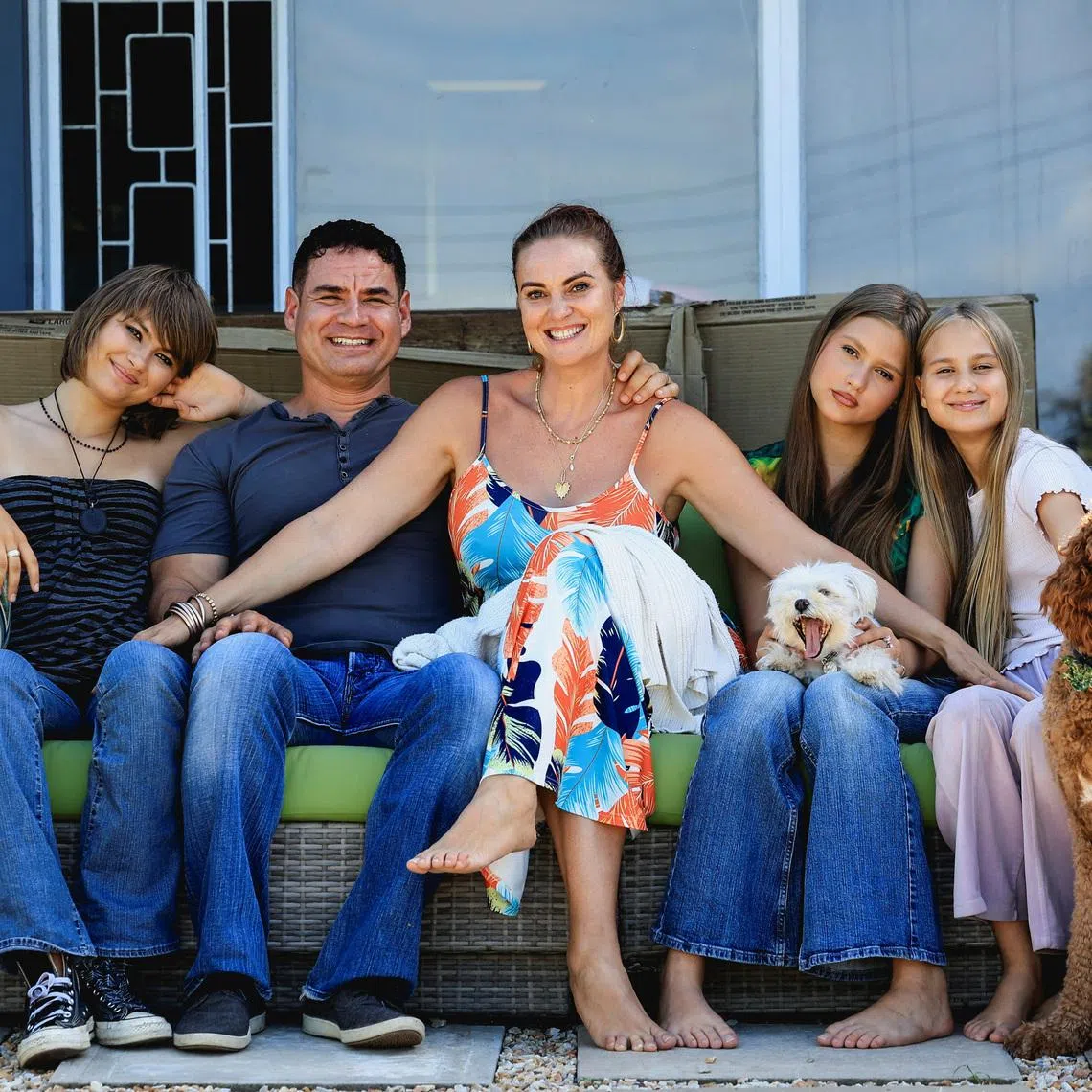 Naomi and Danny Saphire pose with their children and dogs at their new home in Plettenberg Bay after returning from the U.S., in the Western Cape, South Africa, March 7, 2026.