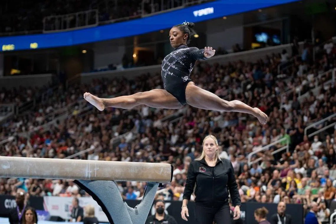 FILE PHOTO: August 27, 2023; San Jose, California, USA; Simone Biles (top) performs on the balance beam in front of World Champions Centre coach Cecile Canqueteau-Landi (bottom) during the 2023 U.S. Gymnastics Championships at SAP Center. Mandatory Credit: Kyle Terada-USA TODAY/File photo