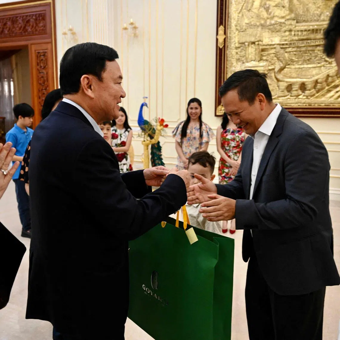 This photo taken on August 5, 2023 shows Thailand’s former prime minister Thaksin Shinawatra (2nd L) offering gift to General Hun Manet (2nd R), Commander of the Royal Cambodian Army and eldest son of Cambodia's Prime Minister Hun Sen, during Hun Sen’s birthday in Phnom Penh. (Photo by AFP)
