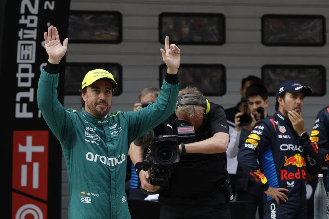 Formula One F1 - Chinese Grand Prix - Shanghai International Circuit, Shanghai, China - April 20, 2024 Aston Martin's Fernando Alonso celebrates after finishing third in qualifying as second placed Red Bull's Sergio Perez looks on REUTERS/Tyrone Siu