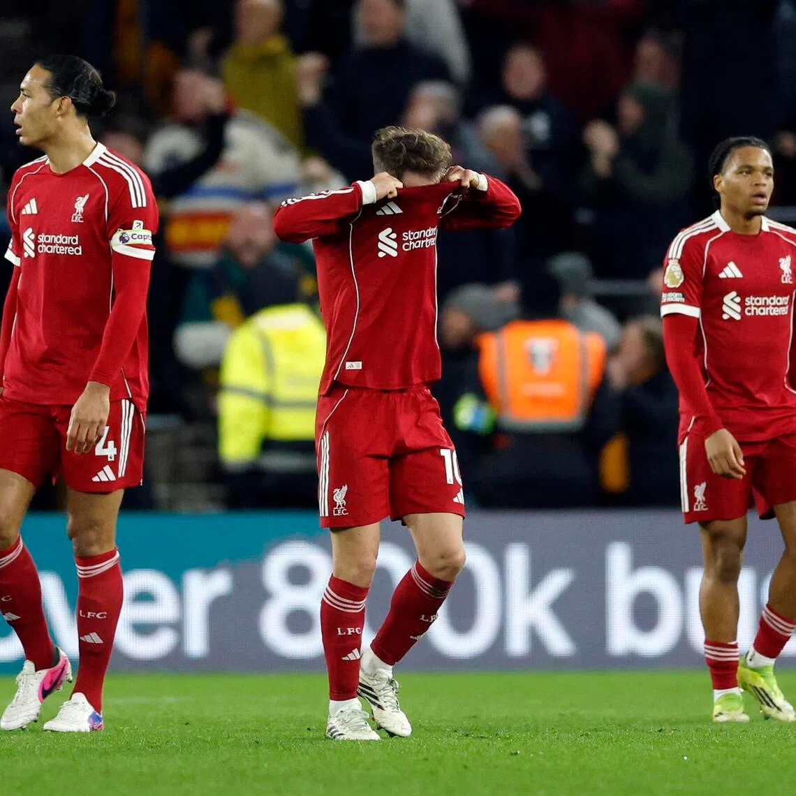 Liverpool's Alexis Mac Allister, Virgil van Dijk and Rio Ngumoha reacting to the winning goal being scored by after Wolverhampton Wanderers' Andre.