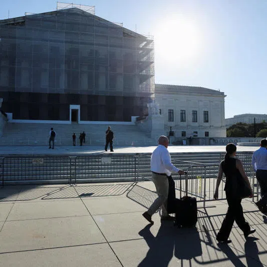 People walk past the US Supreme Court building on the first day of their new session in Washington, US, on Oct 6, 2025.