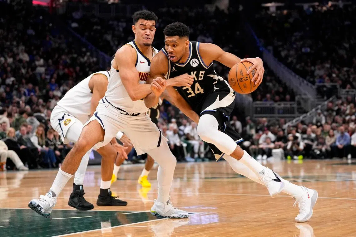 Milwaukee Bucks forward Giannis Antetokounmpo drives for the basket against Denver Nuggets forward Spencer Jones during their NBA game on Jan 23.