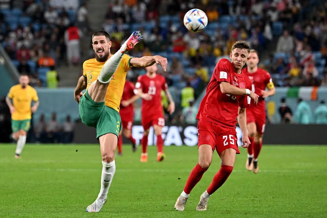 Australia defender Milos Degenek fights for the ball with Denmark midfielder Jesper Lindstrom.
