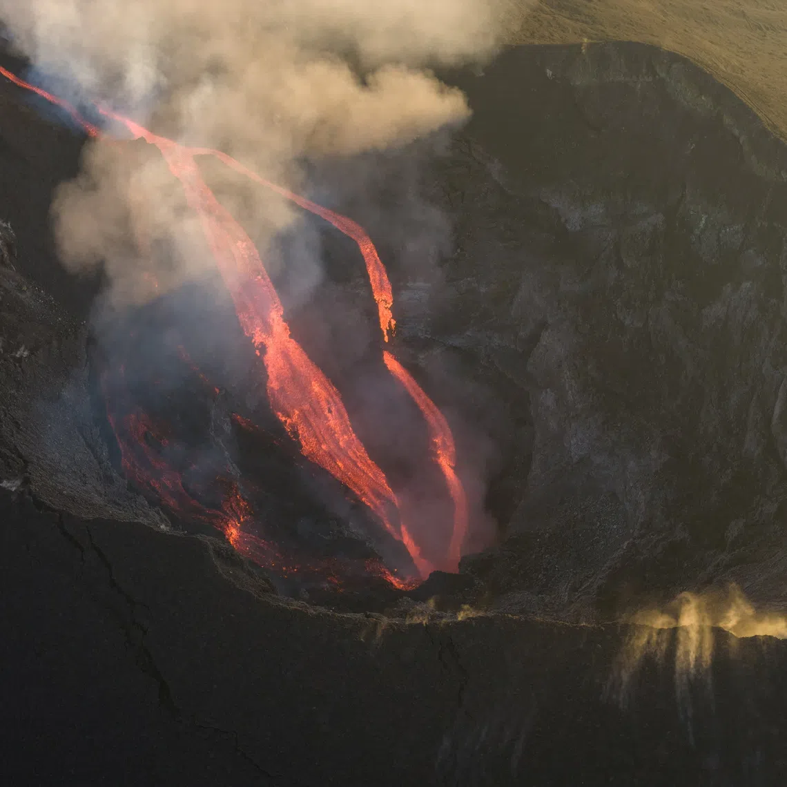 A drone view shows molten lava flowing inside a crater during an eruption of Mount Etna, in Sicily, Italy, August 13, 2026. REUTERS/Giuseppe Di Stefano