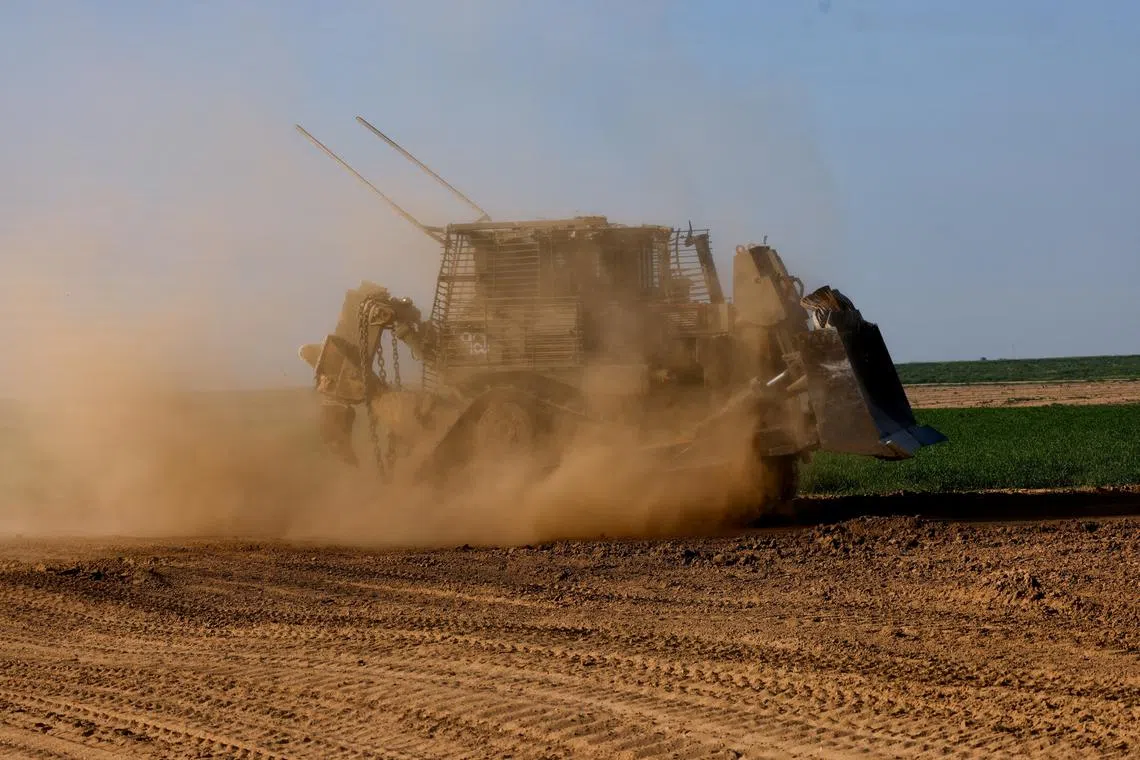 A D9 bulldozer maneuvres near the Israel-Gaza border, amid the ongoing conflict between Israel and the Palestinian Islamist group Hamas, in Israel, February 28, 2024. REUTERS/Amir Cohen/File Photo