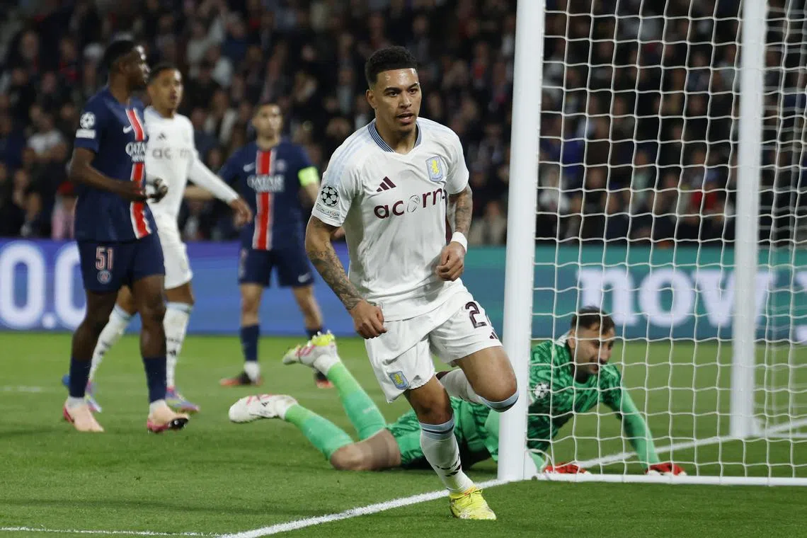 Soccer Football - Champions League - Quarter Final - First Leg - Paris St Germain v Aston Villa - Parc des Princes, Paris, France - April 9, 2025 Aston Villa's Morgan Rogers celebrates scoring their first goal as Paris St Germain's Gianluigi Donnarumma looks dejected REUTERS/Stephanie Lecocq