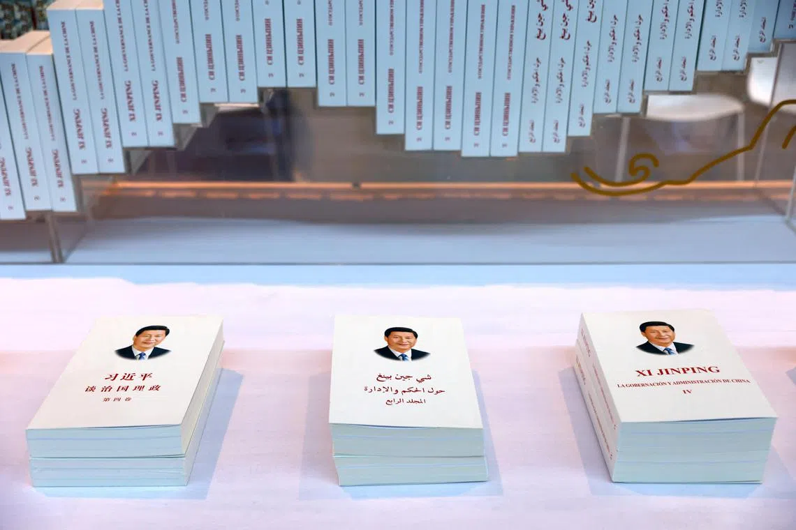 Copies of "Xi Jinping: The Governance of China" in Arabic and Spanish are displayed at outside the media center ahead of the Third Belt and Road Forum in Beijing, China October 16, 2023. REUTERS/Edgar Su