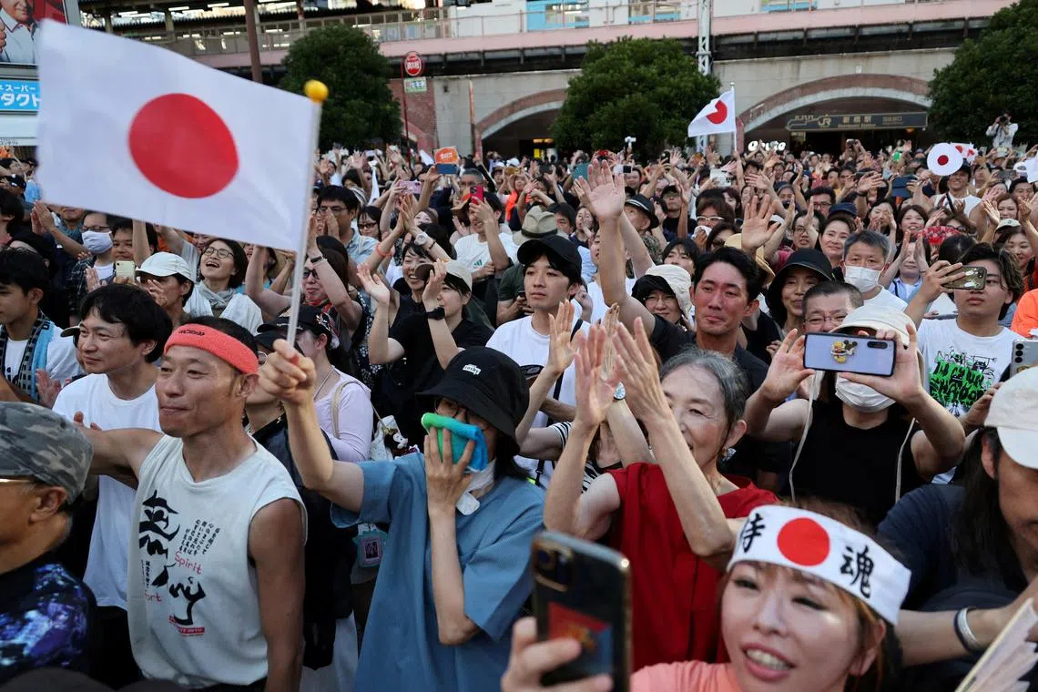 Supporters of Japan's Sanseito party leader react during the party’s rally in Tokyo, Japan.