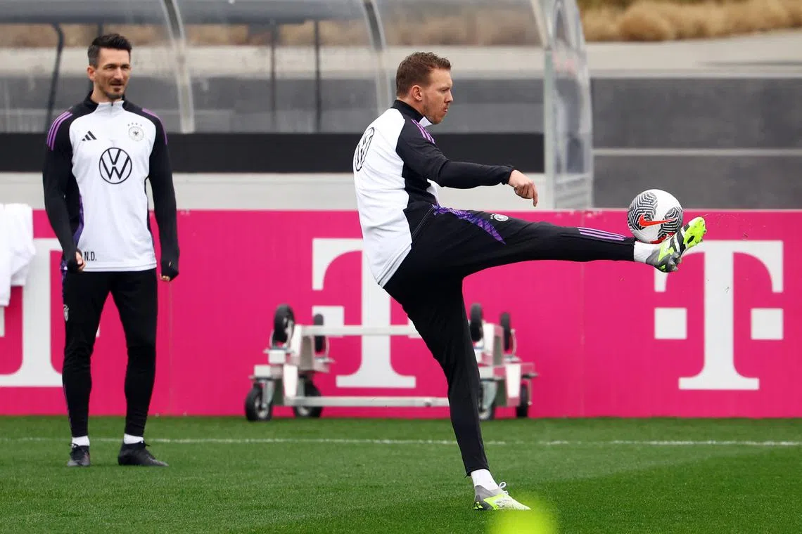 Soccer Football - International Friendly - Germany Training - DFB Campus, Frankfurt, Germany - March 19, 2024 Germany coach Julian Nagelsmann during training as fitness coach Nicklas Dietrich looks on REUTERS/Kai Pfaffenbach
