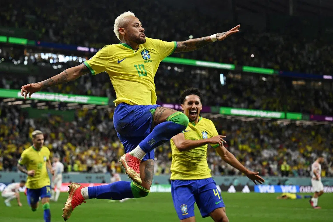 Neymar celebrates scoring for Brazil with teammate Marquinhos.