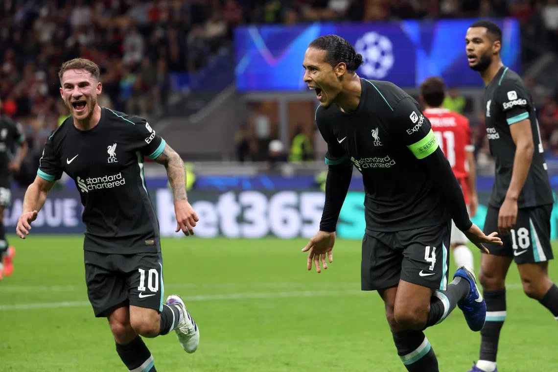 Liverpool’s Virgil van Dijk (right) celebrates scoring his team's second goal against AC Milan.