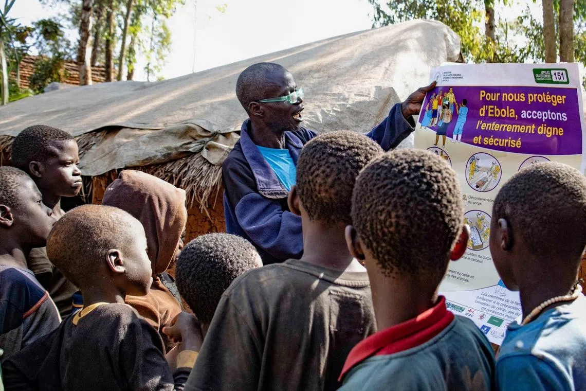 FILE PHOTO: Dz'na Lipe Jean‑Marie, secretary of the displacement camp, speaks during an Ebola awareness session as humanitarian agencies intensify efforts to contain a new Ebola outbreak involving the Bundibugyo strain, at Kpangba displacement camp where Ebola cases were observed, Djugu territory in Ituri province, Democratic Republic of Congo, June 13, 2026. REUTERS/Gradel Muyisa Mumbere./File Photo