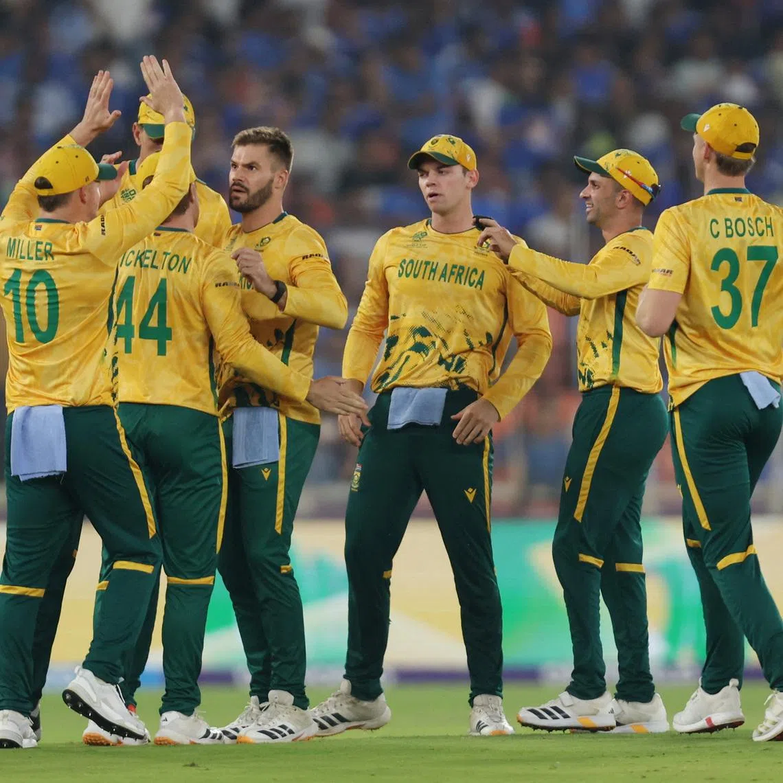 Cricket - ICC Men's T20 World Cup 2026 - Super 8 - India v South Africa - Narendra Modi Stadium, Ahmedabad, India - February 22, 2026 South Africa's Aiden Markram celebrates with teammates after taking the wicket of India's Ishan Kishan, caught out by Ryan Rickelton REUTERS/Amit Dave