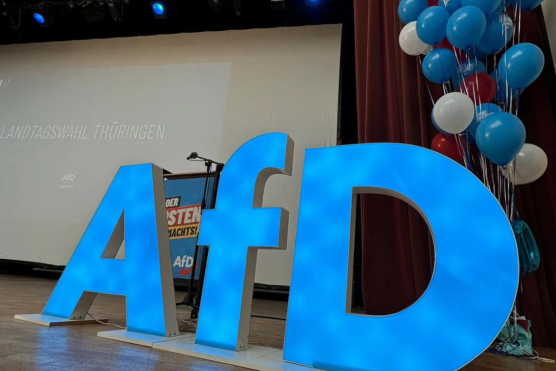 FILE PHOTO: The AfD logo is pictured on stage before an election campaign rally of Bjoern Hoecke, leader of the Alternative for Germany in Thuringia, the state in east Germany where polls say his party could take 29% of the vote in September, in Arnstadt, Germany, July 20, 2024.     REUTERS/Thomas Escritt/File Photo