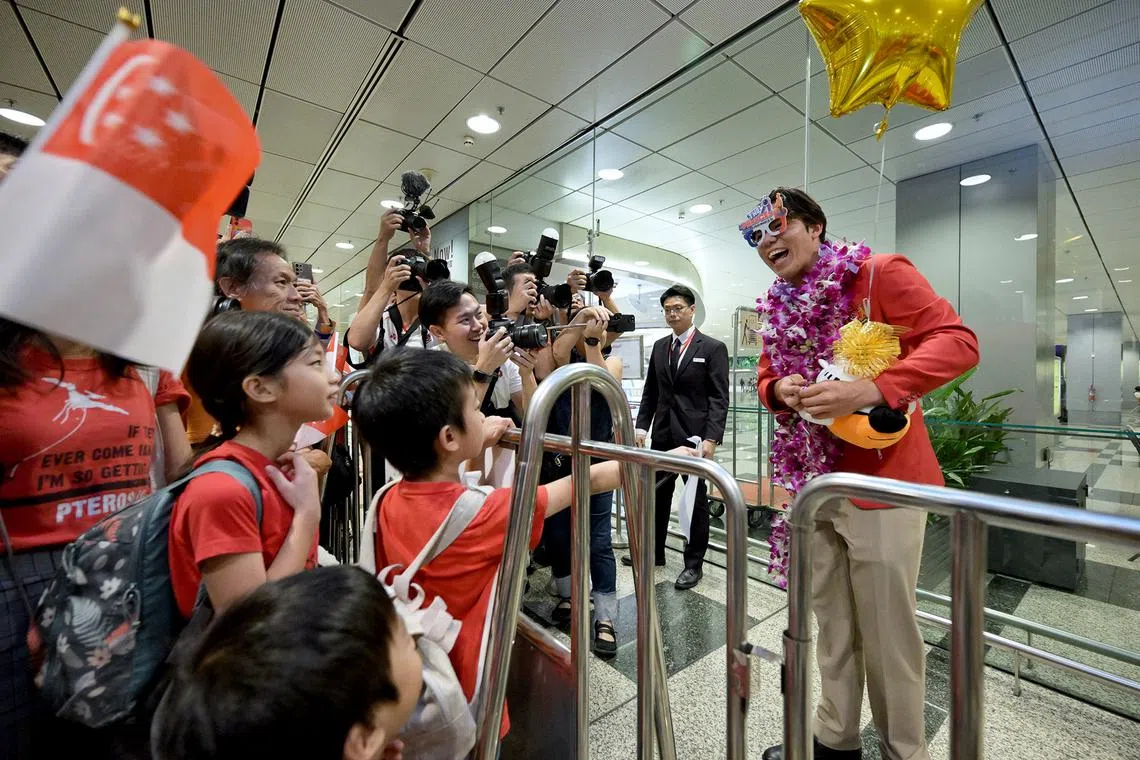 Singapore's Olympic bronze medallist Max Maeder gamely puts on a pair of frames gifted to him by young fans.