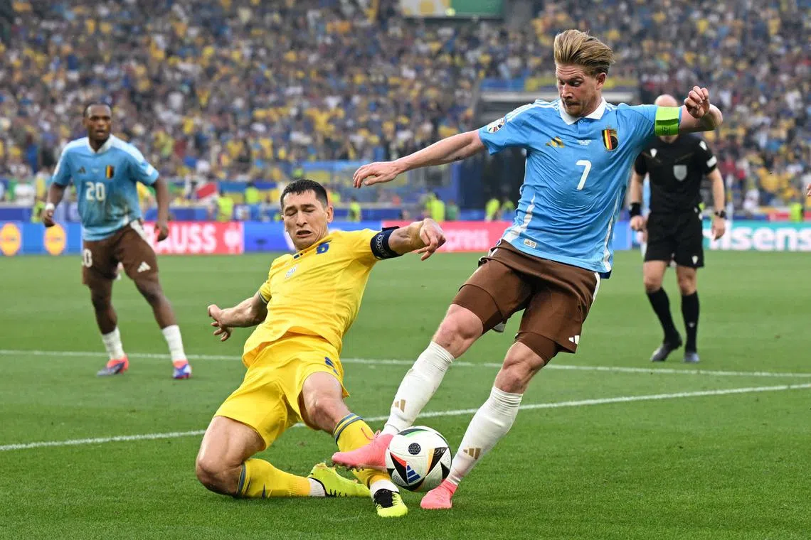 Soccer Football - Euro 2024 - Group E - Ukraine v Belgium - Stuttgart Arena, Stuttgart, Germany - June 26, 2024 Ukraine's Taras Stepanenko in action with Belgium's Kevin De Bruyne REUTERS/Angelika Warmuth