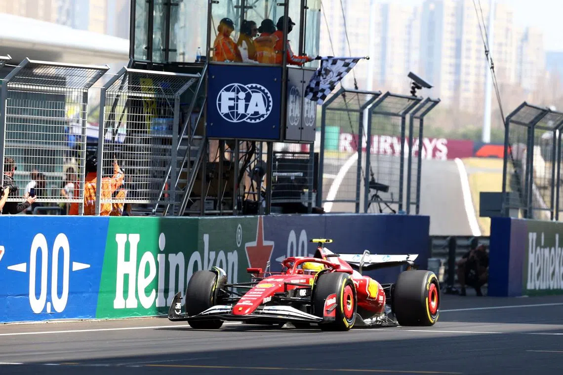 Formula One F1 - Chinese Grand Prix - Shanghai International Circuit, Shanghai, China - March 22, 2025 Ferrari's Lewis Hamilton takes the checkered flag to win the sprint REUTERS/Edgar Su
